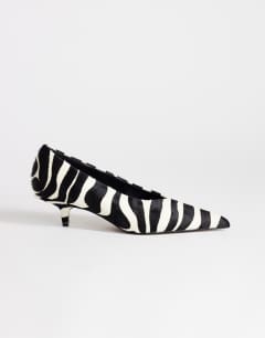 Model wearing Avril hair on real leather kitten heel mid court shoe in black and white zebra