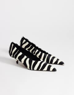 Model wearing Avril hair on real leather kitten heel mid court shoe in black and white zebra