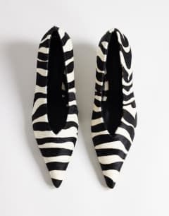 Model wearing Avril hair on real leather kitten heel mid court shoe in black and white zebra