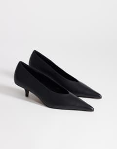 Model wearing Avril kitten heel mid court shoe in black