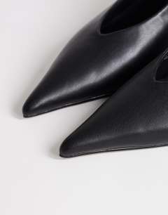Model wearing Avril kitten heel mid court shoe in black