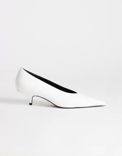 Model wearing Avril kitten heel mid court shoe in white