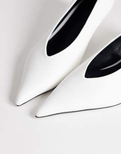 Model wearing Avril kitten heel mid court shoe in white