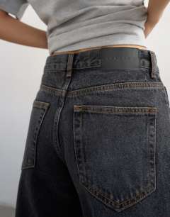 Model wearing Awkward crop jean in washed black