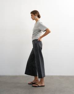 Model wearing Awkward crop jean in washed black