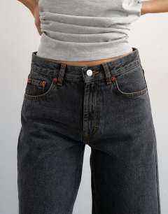 Model wearing Awkward crop jean in washed black