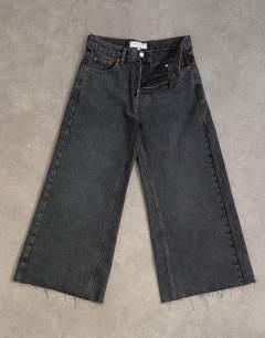 Model wearing Awkward crop jean in washed black