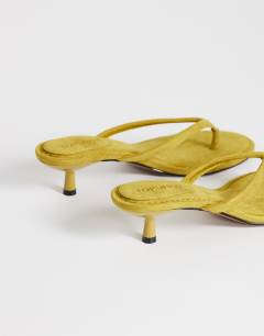 Model wearing Axel toe thong mid heel sandal in olive