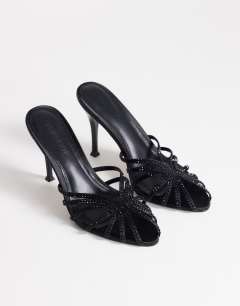 Model wearing Azelia heeled sandal  with gems in black satin