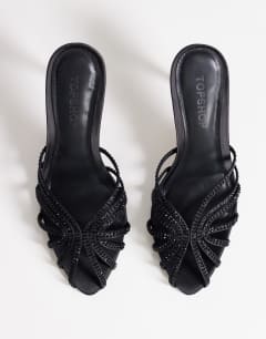 Model wearing Azelia heeled sandal  with gems in black satin