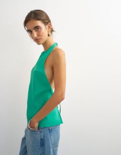 Model wearing Backless detail halter top in green