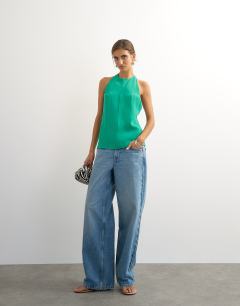 Model wearing Backless detail halter top in green
