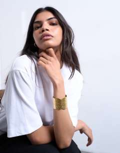 Model wearing Bala stainless steel hammered cuff bracelet in gold tone