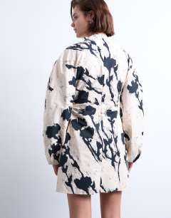 Model wearing Balloon sleeve cinch waist mini dress in mono floral print