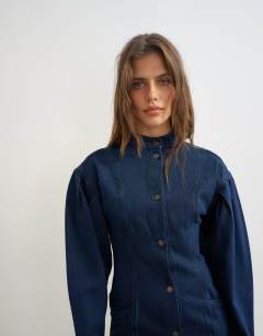 Model wearing Balloon sleeve mock neck mini dress in blue denim