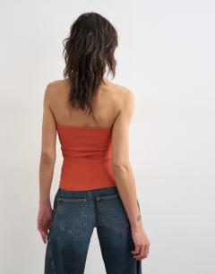 Model wearing Bandeau button detail top in coral