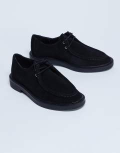 Model wearing Banks real suede leather lace up shoe in black