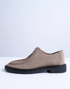 Model wearing Banks real suede leather lace up shoe in taupe