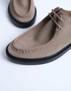 Model wearing Banks real suede leather lace up shoe in taupe