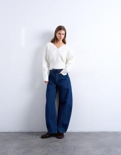 Model wearing Barge barrel high rise jean in indigo rinse