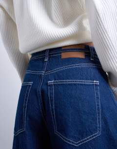 Model wearing Barge barrel high rise jean in indigo rinse