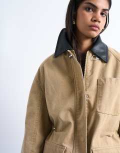 Model wearing Barn jacket with buckle detail in tan