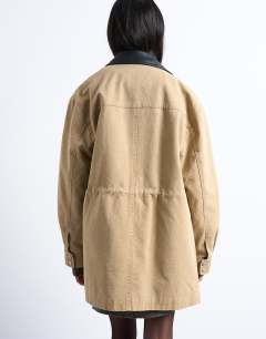 Model wearing Barn jacket with buckle detail in tan