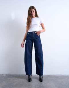 Model wearing Barrel high rise jean circular design in indigo rinse