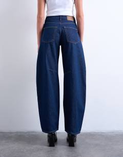 Model wearing Barrel high rise jean circular design in indigo rinse
