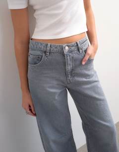 Model wearing Barrel high rise jean circular design in pretty grey
