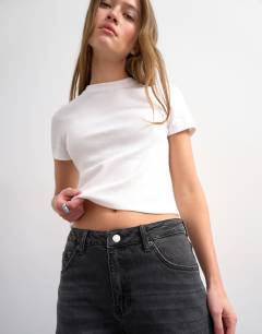 Model wearing Barrel high rise jean circular design in washed black