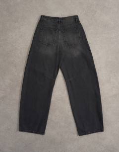 Model wearing Barrel high rise jean circular design in washed black