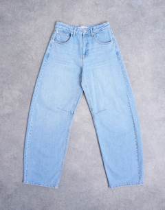 Model wearing Barrel high rise jean in bleach