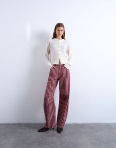 Model wearing Barrel jean in red and pink