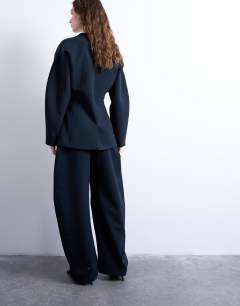 Model wearing Barrel leg tailored trousers in navy