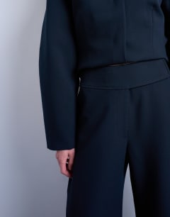 Model wearing Barrel leg tailored trousers in navy