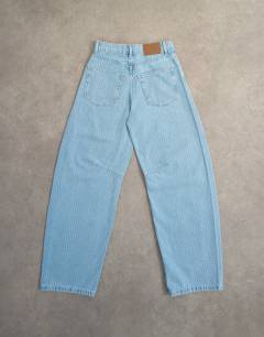 Model wearing Barrel mid rise jean in bleach pinstripe