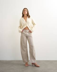Model wearing Barrel mid rise jean in blue and natural stripe