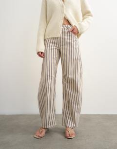 Model wearing Barrel mid rise jean in blue and natural stripe