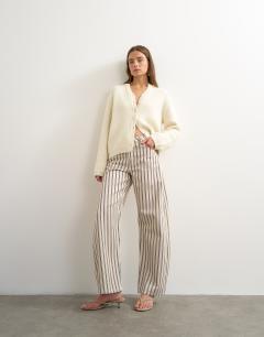 Model wearing Barrel mid rise jean in blue and natural stripe