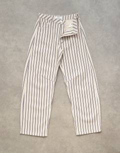 Model wearing Barrel mid rise jean in blue and natural stripe