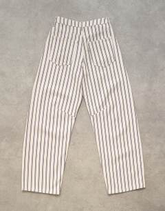 Model wearing Barrel mid rise jean in blue and natural stripe