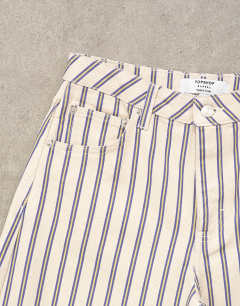Model wearing Barrel mid rise jean in blue and natural stripe