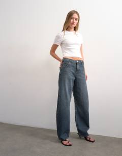 Model wearing Barrel mid rise jean in blue black