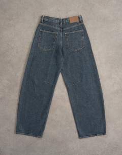Model wearing Barrel mid rise jean in blue black