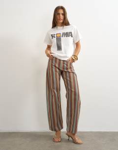 Model wearing Barrel mid rise jean in brown and blue stripe