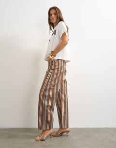 Model wearing Barrel mid rise jean in brown and blue stripe