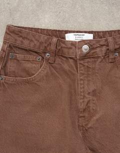 Model wearing Barrel mid rise jean in chocolate