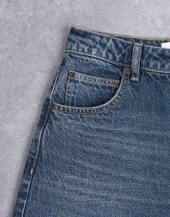 Model wearing Barrel mid rise jean in deep blue