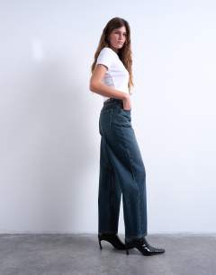 Model wearing Barrel mid rise jean in deep blue